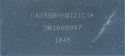 Close-up of a dark surface showing stamped alphanumeric codes: FAB8GBHSMI21C1K, 0M1006387, 1045.