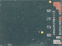 Close-up of a dark green circuit board edge with a row of gold connector pins on the right and orange test pads nearby.