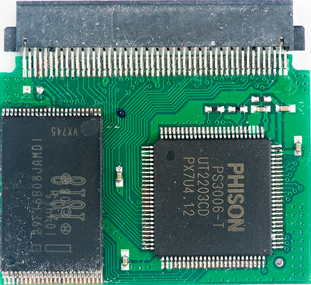 Close-up of a green PCB with two black integrated circuits, including a PHISON PS3006-T chip, and a large edge connector at the top.