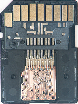 Close-up of a memory card's connector area, showing gold contact pads and exposed circuit board.